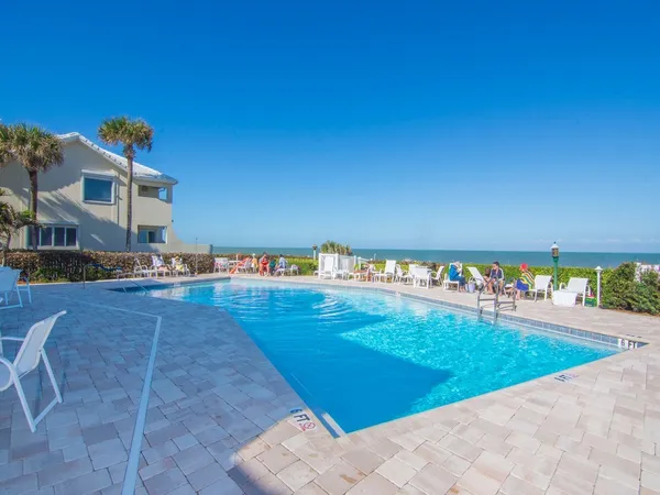 a view of swimming pool with outdoor seating and plants