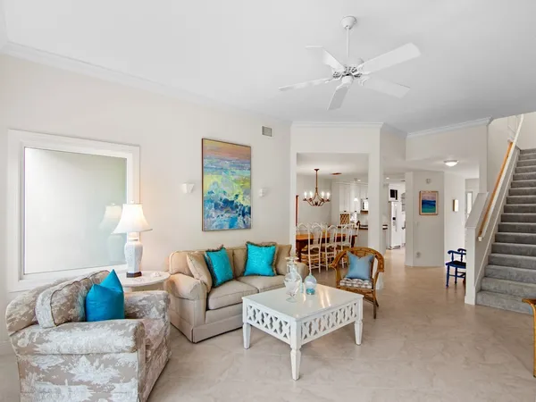 a living room with furniture and a chandelier