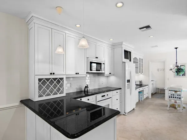 a kitchen with stainless steel appliances granite countertop a sink stove and cabinets