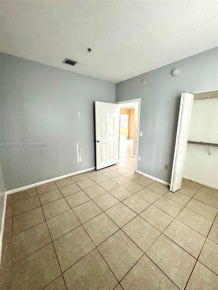 4402 Southwest 160th Avenue, Unit 910 Miramar, FL 33027 - Photo 11 of 22 a view of an empty room and window