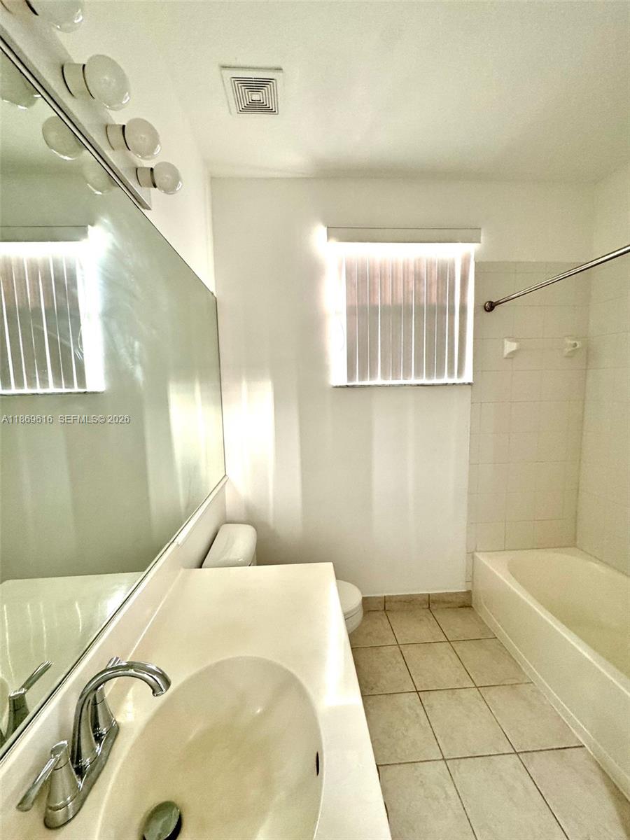 4402 Southwest 160th Avenue, Unit 910 Miramar, FL 33027 - Photo 13 of 22 a bathroom with a bathtub and shower