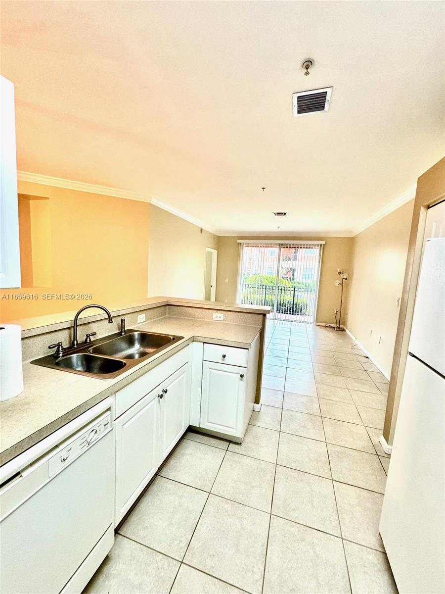 4402 Southwest 160th Avenue, Unit 910 Miramar, FL 33027 - Photo 6 of 22 a large kitchen with a sink and cabinets