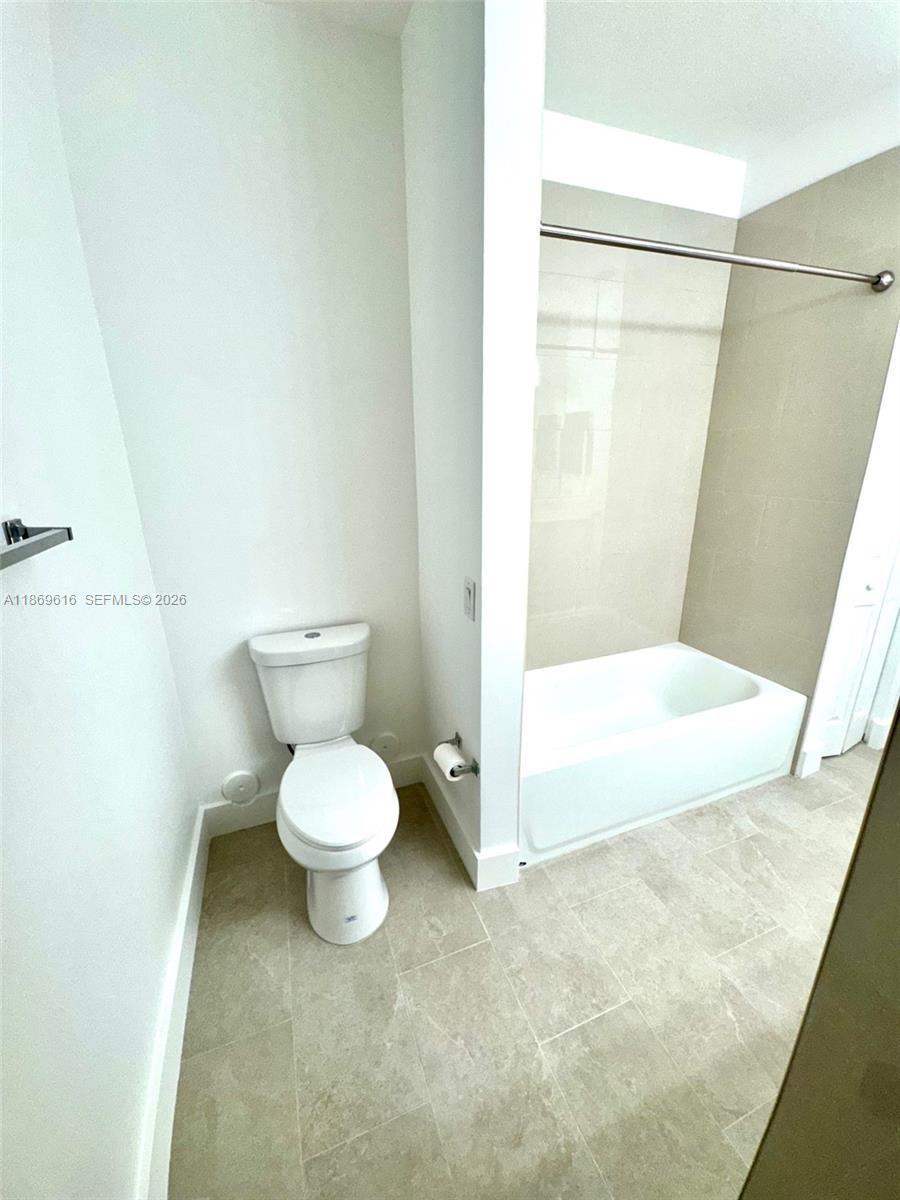 4402 Southwest 160th Avenue, Unit 910 Miramar, FL 33027 - Photo 9 of 22 a bathroom with a toilet and a shower