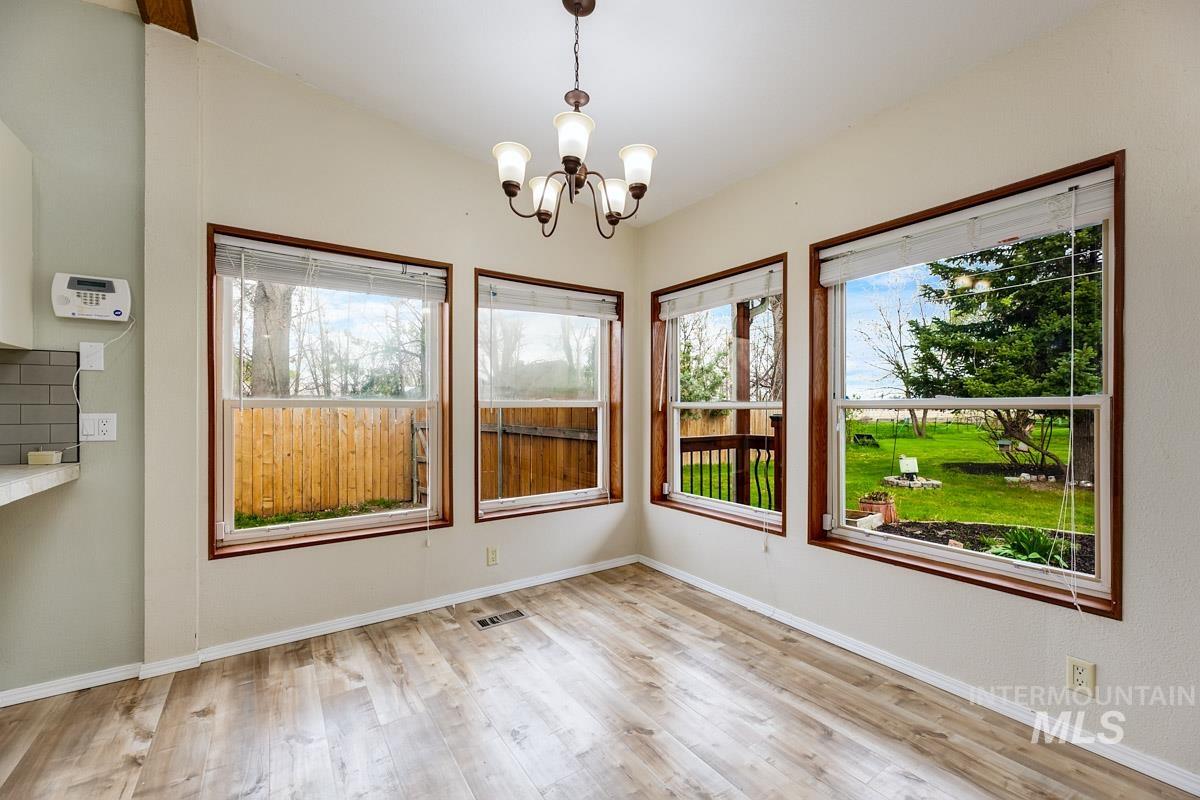 10131 Highway 44 Middleton, ID 83644 - Photo 11 of 42 Unfurnished dining area featuring light wood finished floors and hanging lights