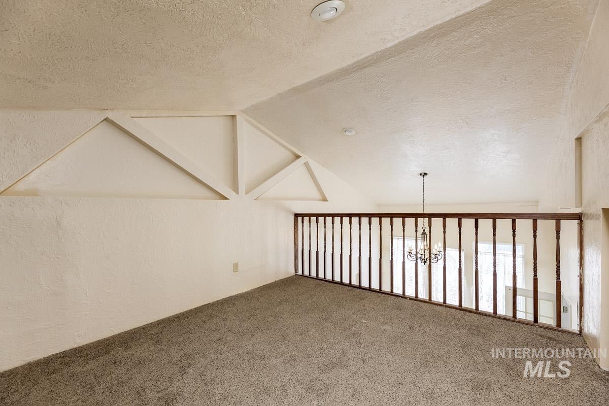 10131 Highway 44 Middleton, ID 83644 - Photo 27 of 42 Additional living space with carpet flooring and suspended lighting