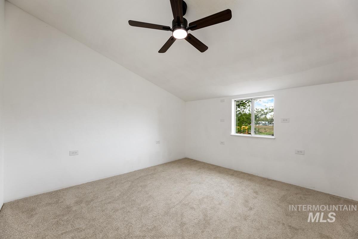 10131 Highway 44 Middleton, ID 83644 - Photo 29 of 42 Unfurnished room featuring lofted ceiling, carpet, and ceiling fan