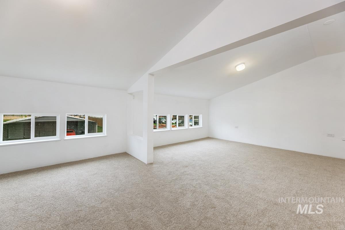 10131 Highway 44 Middleton, ID 83644 - Photo 30 of 42 Carpeted spare room with lofted ceiling