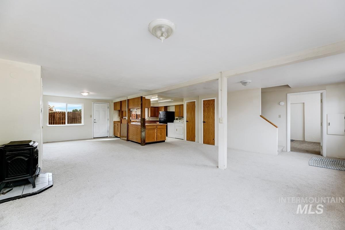 10131 Highway 44 Middleton, ID 83644 - Photo 32 of 42 Unfurnished living room featuring a wood stove and light carpet