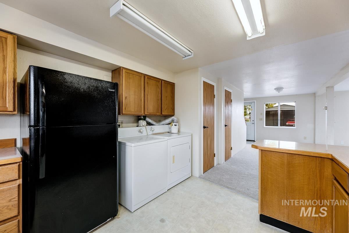 10131 Highway 44 Middleton, ID 83644 - Photo 35 of 42 Laundry area with light floors and washing machine and clothes dryer