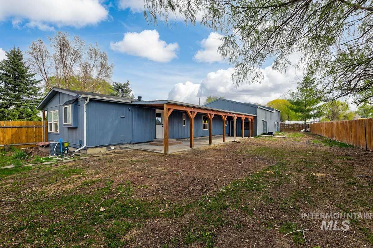 10131 Highway 44 Middleton, ID 83644 - Photo 39 of 42 Rear view of house featuring a fenced backyard and a patio