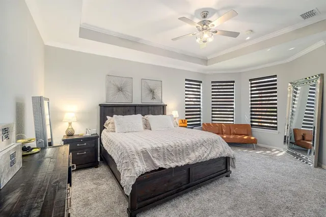 a bedroom with a bed and a chandelier