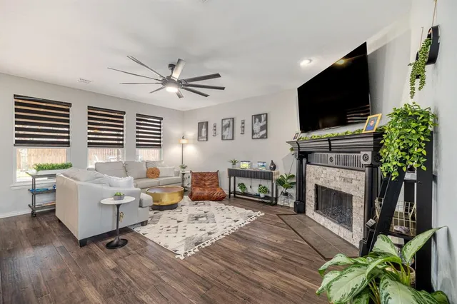 a living room with furniture a fireplace and a flat screen tv