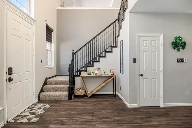 a view of entryway and hall with wooden floor