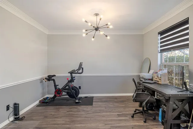 a view of a workspace with furniture and a window