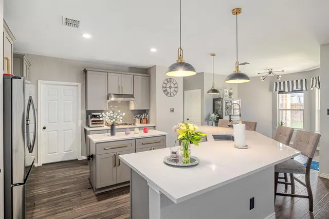 a kitchen with sink cabinets and dining table