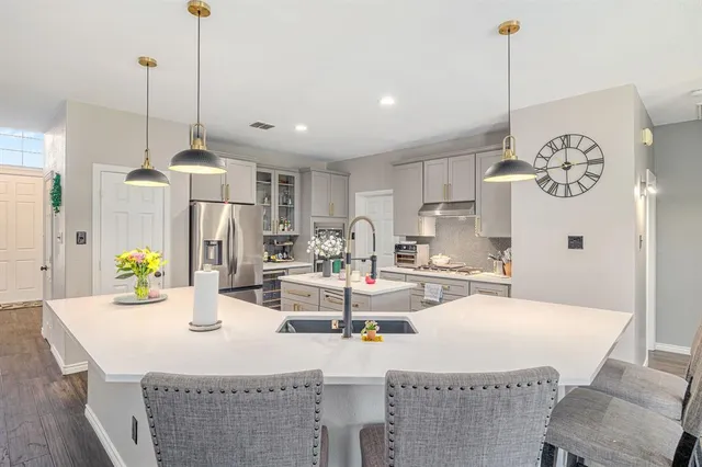 a view of kitchen with dining table and refrigerator