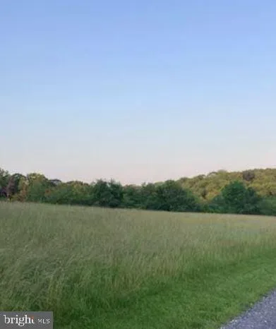 a view of a lake and green valley