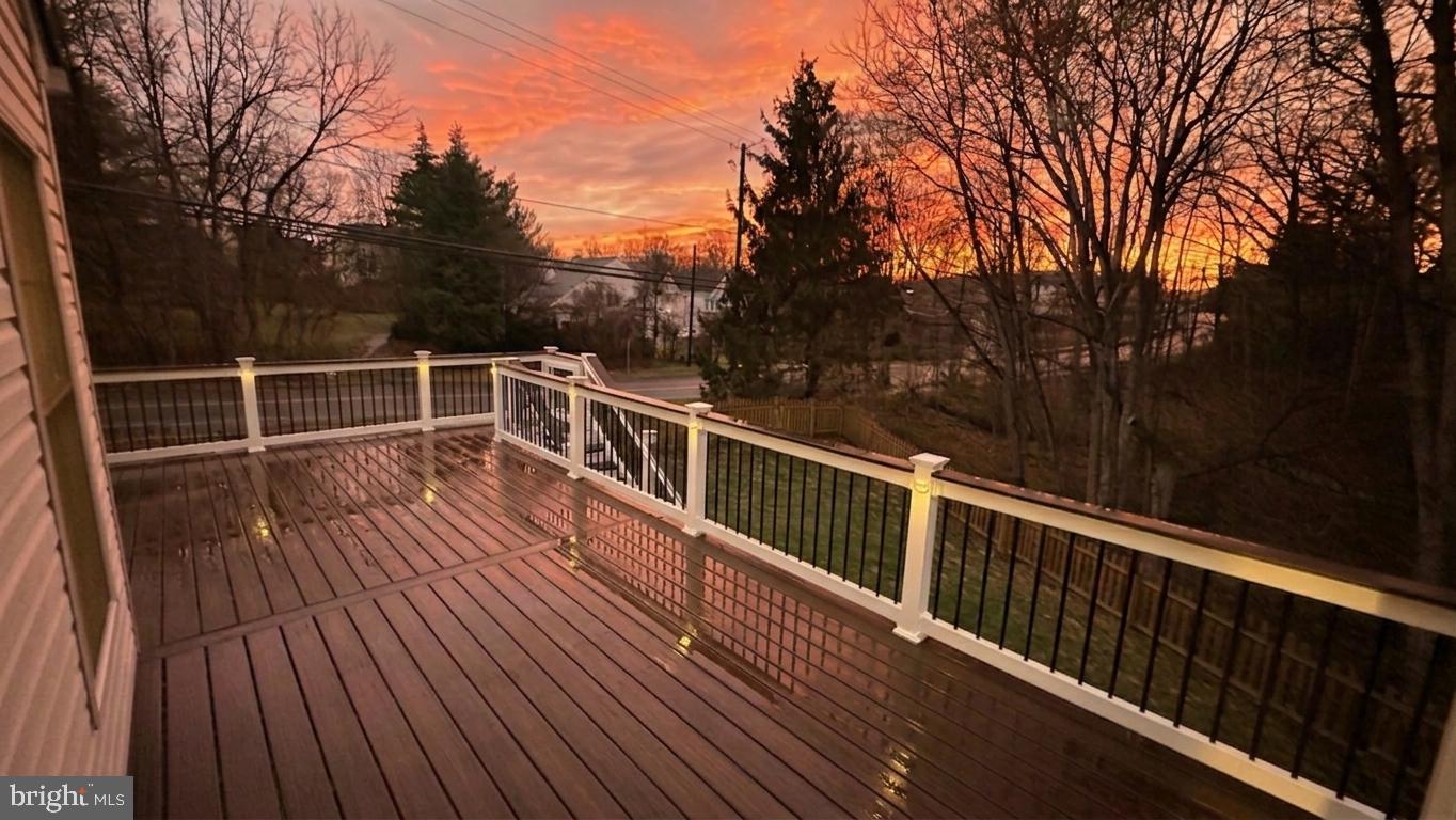 18500 Gingerbread Lane Gaithersburg, MD 20877 - Photo 2 of 56 a view of deck with trees and wooden floor and fence