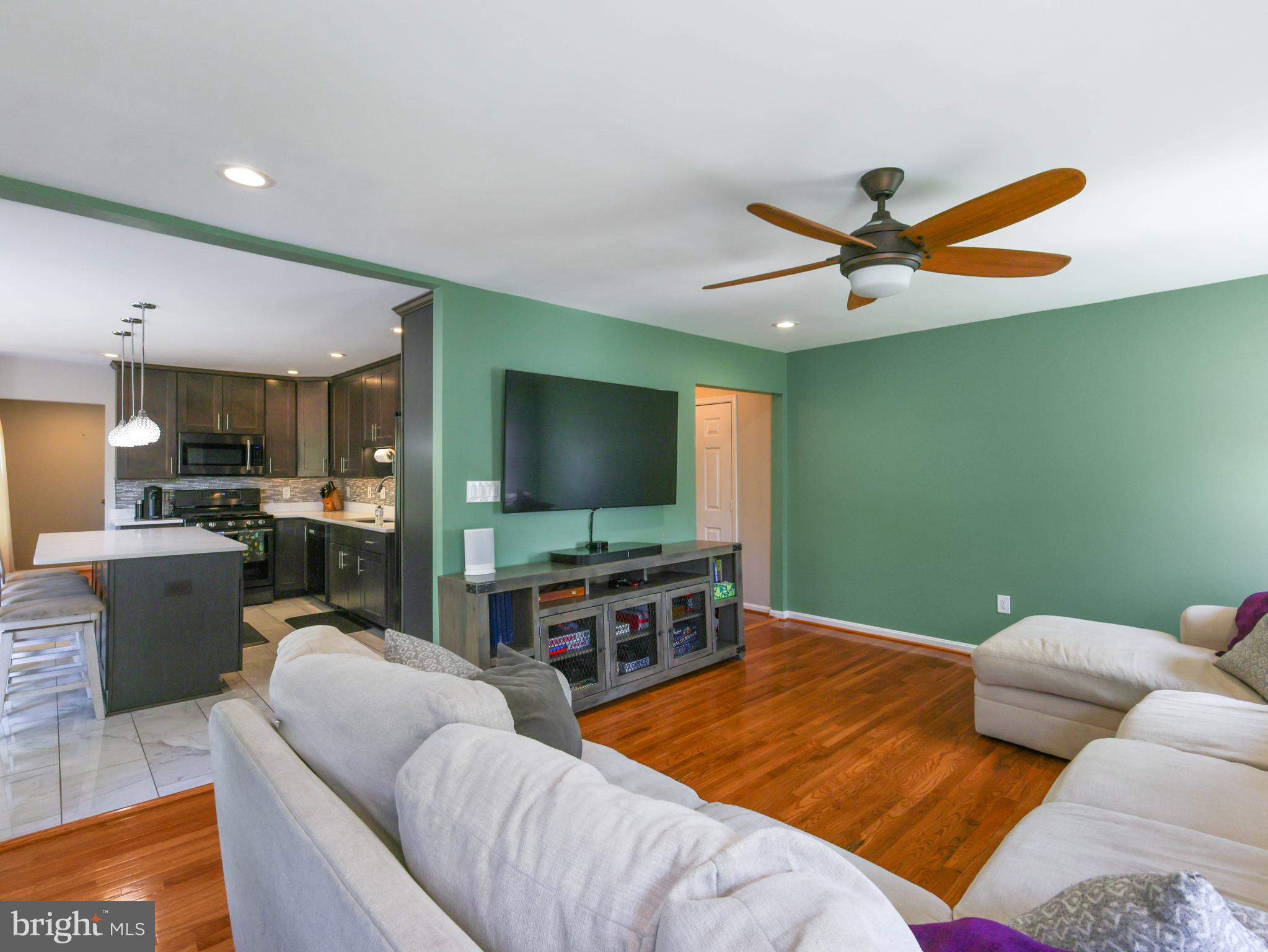 18500 Gingerbread Lane Gaithersburg, MD 20877 - Photo 21 of 56 a living room with furniture and a flat screen tv