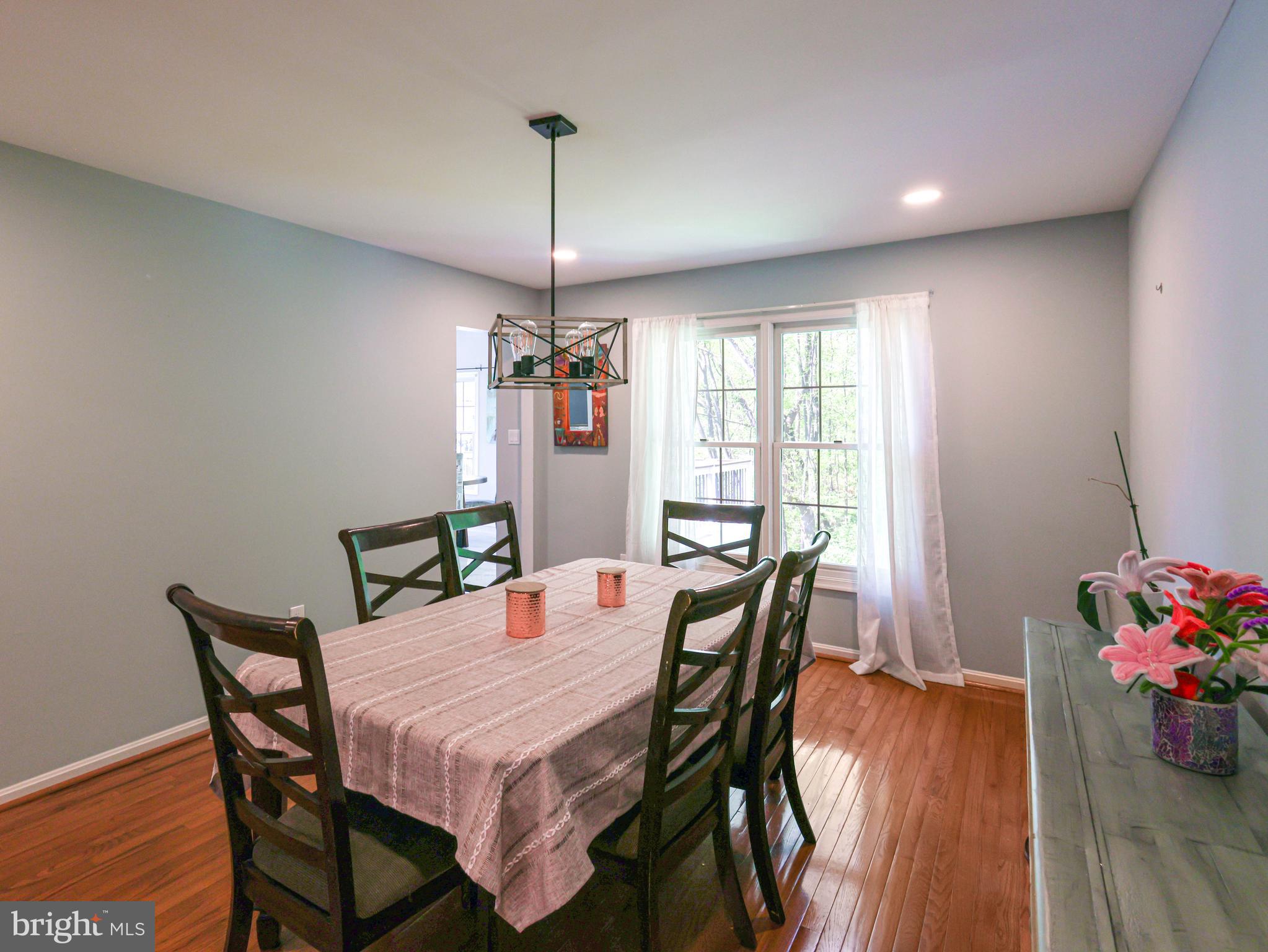 18500 Gingerbread Lane Gaithersburg, MD 20877 - Photo 22 of 56 a view of a dining room with furniture window and wooden floor