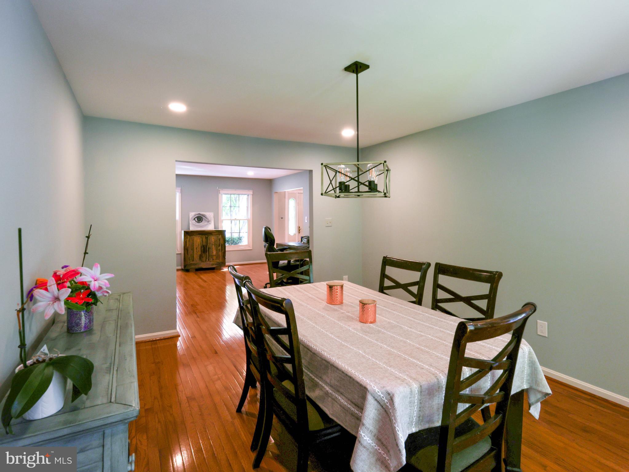 18500 Gingerbread Lane Gaithersburg, MD 20877 - Photo 23 of 56 a view of a dining room with furniture and wooden floor
