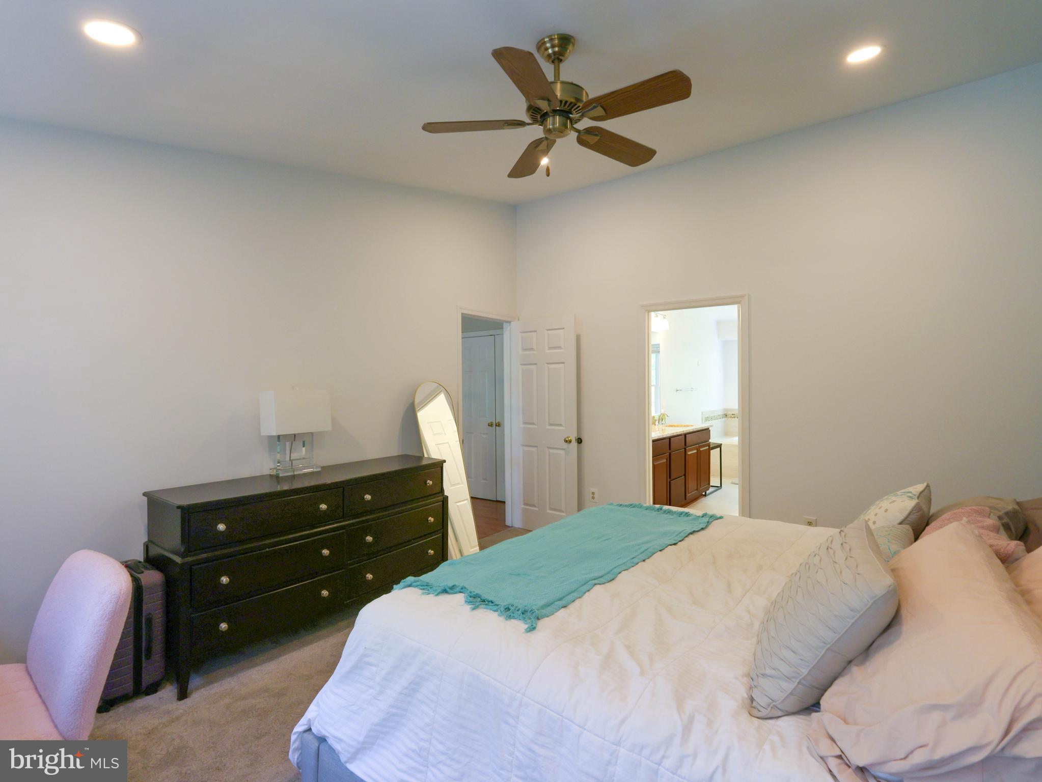 18500 Gingerbread Lane Gaithersburg, MD 20877 - Photo 26 of 56 a bedroom with a bed and a chandelier