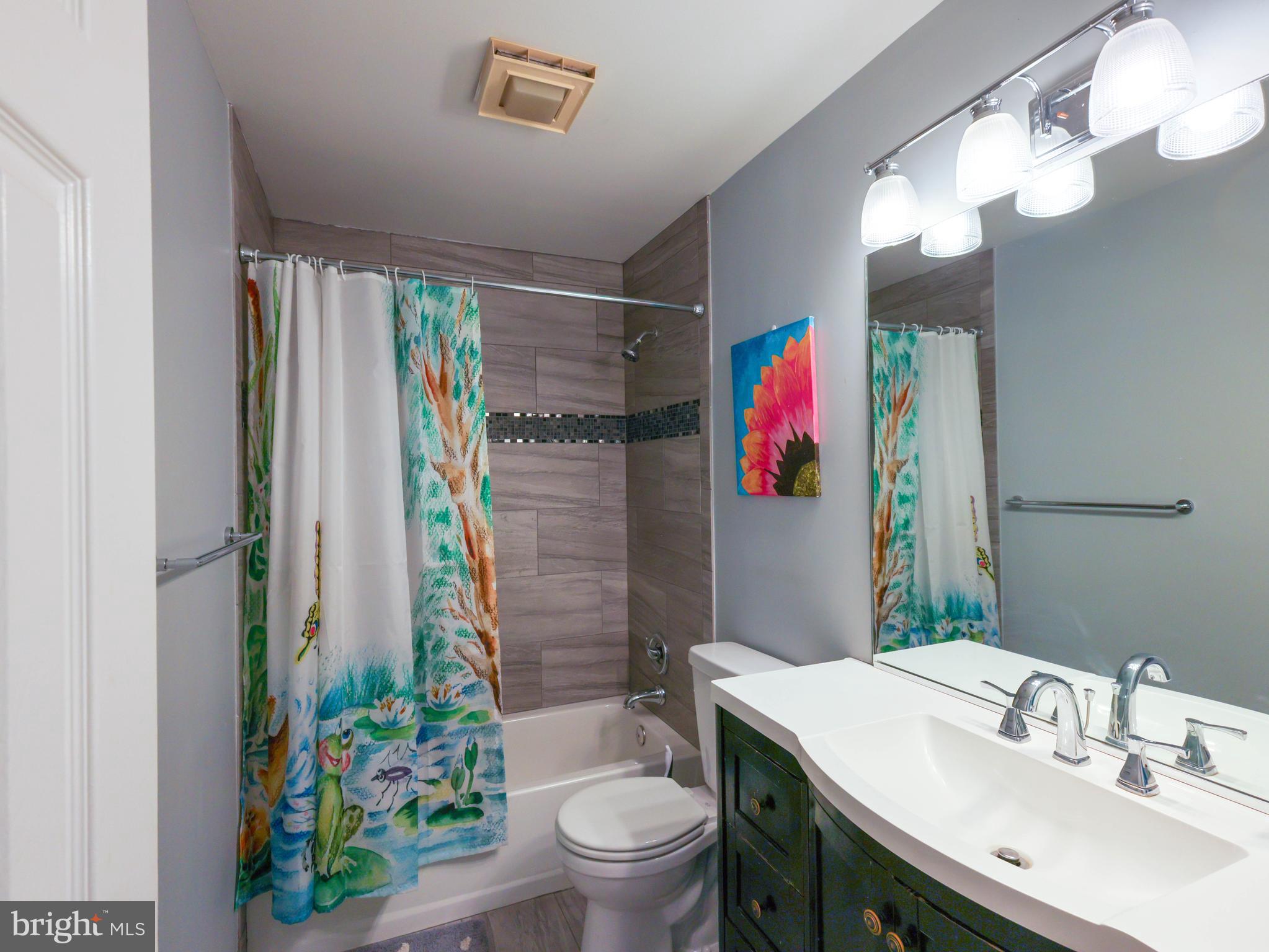 18500 Gingerbread Lane Gaithersburg, MD 20877 - Photo 30 of 56 a bathroom with a sink toilet and shower