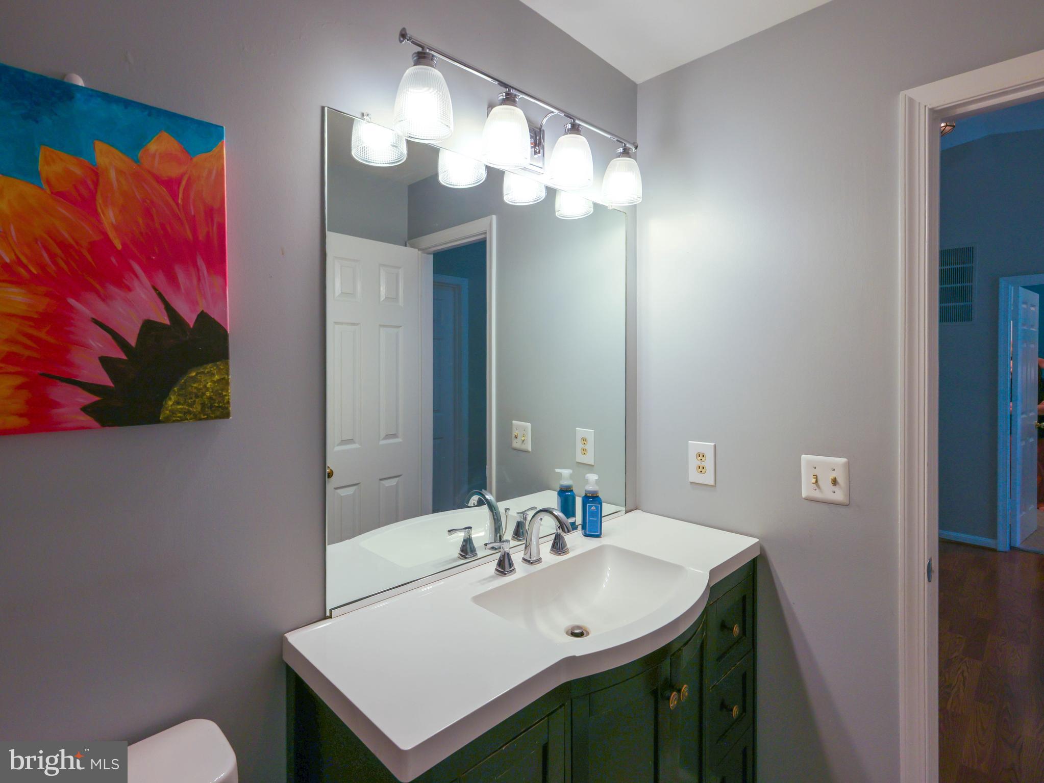 18500 Gingerbread Lane Gaithersburg, MD 20877 - Photo 31 of 56 a bathroom with a sink a mirror and a toilet