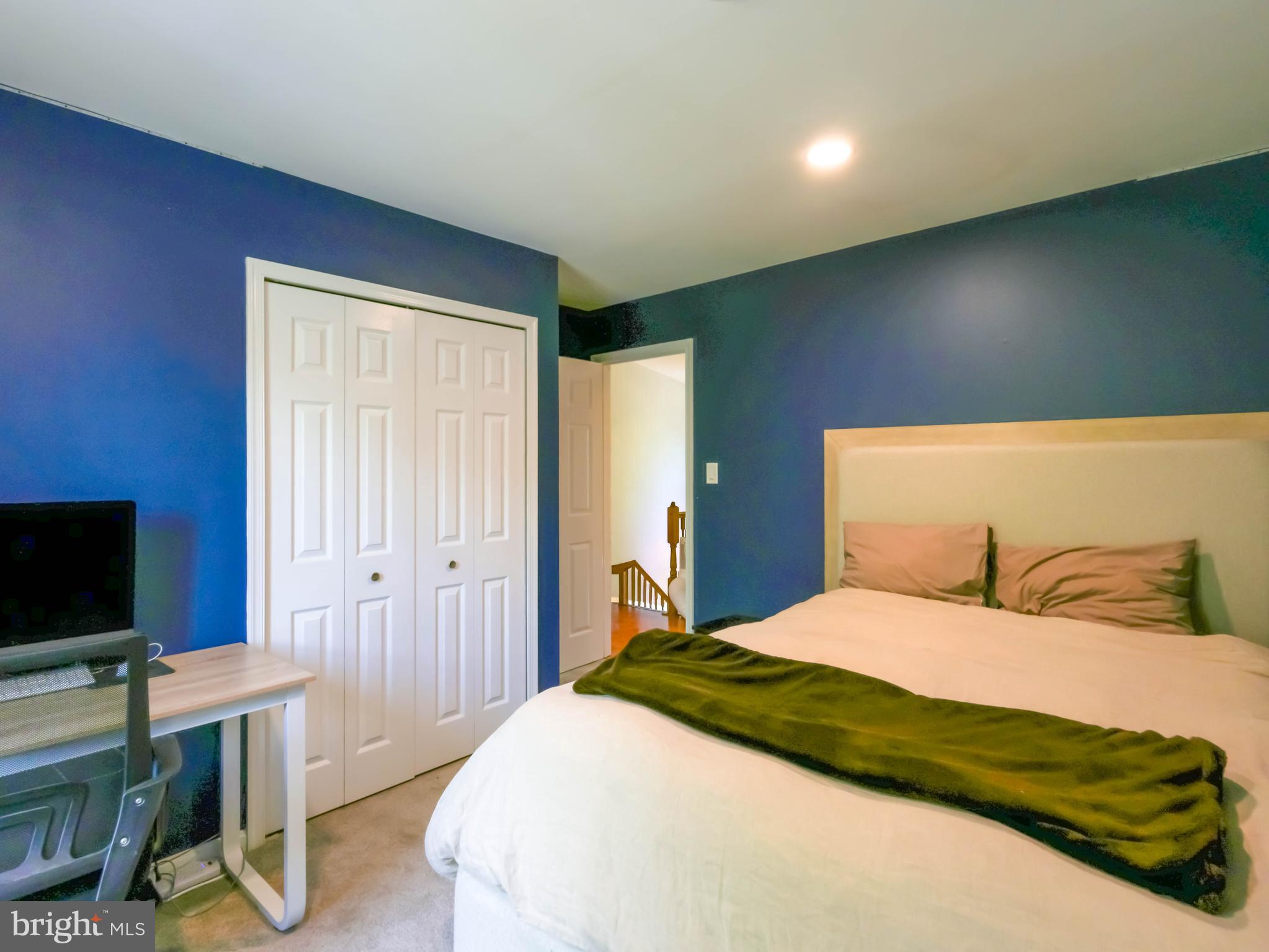 18500 Gingerbread Lane Gaithersburg, MD 20877 - Photo 34 of 56 a bedroom with a bed and a flat screen tv