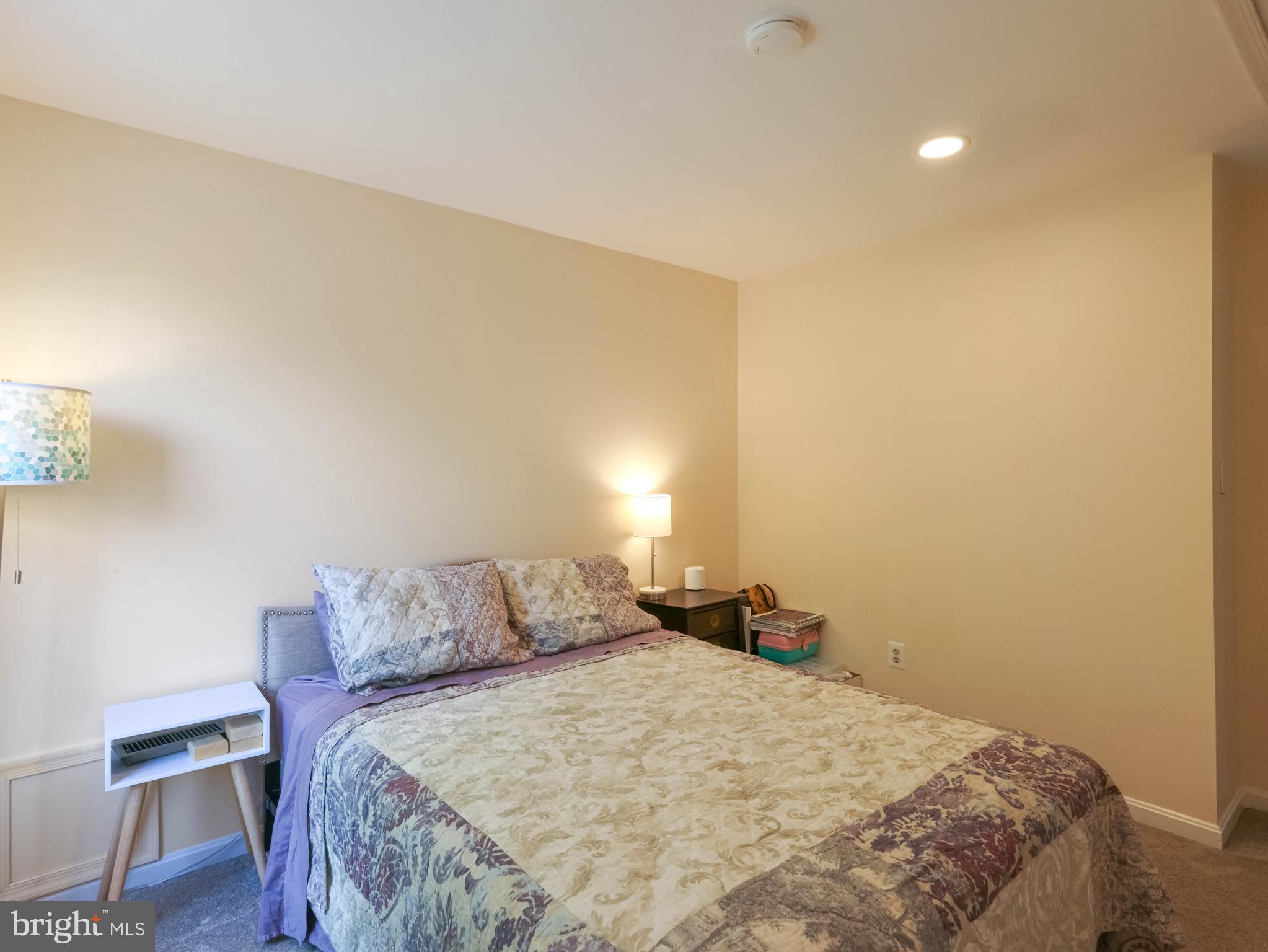 18500 Gingerbread Lane Gaithersburg, MD 20877 - Photo 39 of 56 a bedroom with a bed and a lamp on table