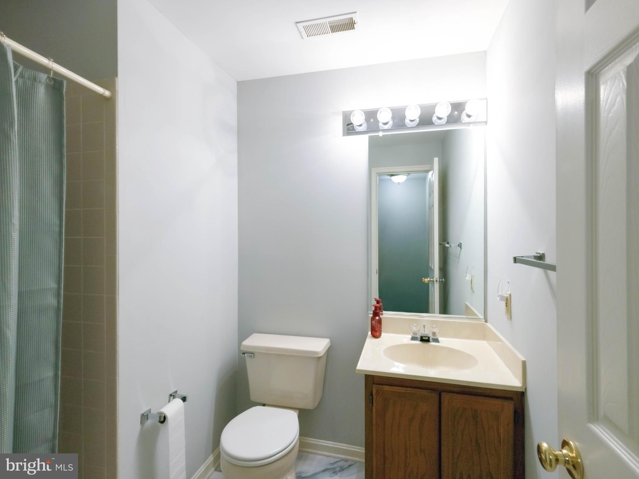 18500 Gingerbread Lane Gaithersburg, MD 20877 - Photo 44 of 56 a bathroom with a toilet sink and mirror