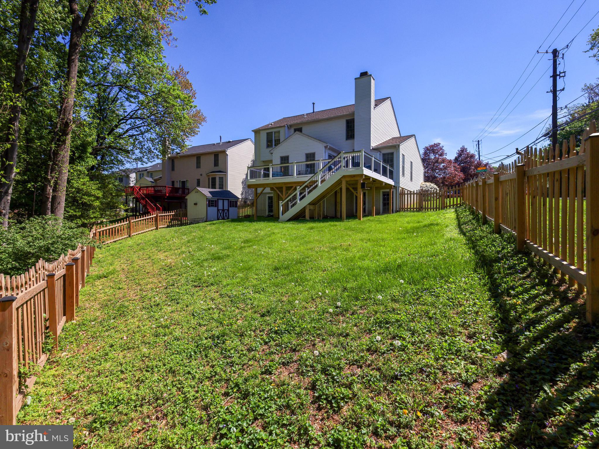 18500 Gingerbread Lane Gaithersburg, MD 20877 - Photo 50 of 56 a view of a house with a yard and deck