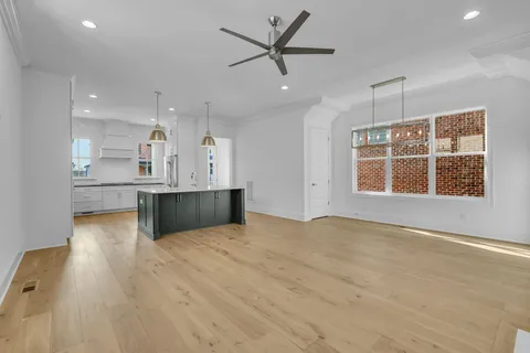 a view of an empty room with kitchen appliances and a window