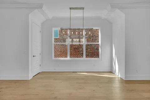 an empty room with cabinet and windows