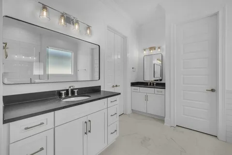 a bathroom with a double vanity sink and mirror