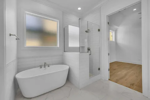 a bathroom with a tub shower and sink