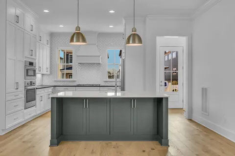 a kitchen with kitchen island a counter top space appliances and cabinets