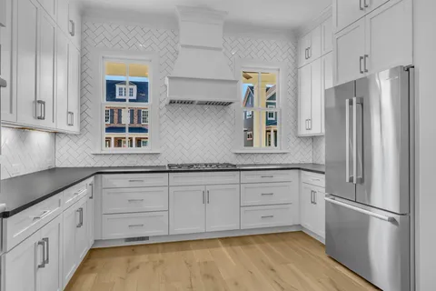 a kitchen with stainless steel appliances a refrigerator sink and cabinets