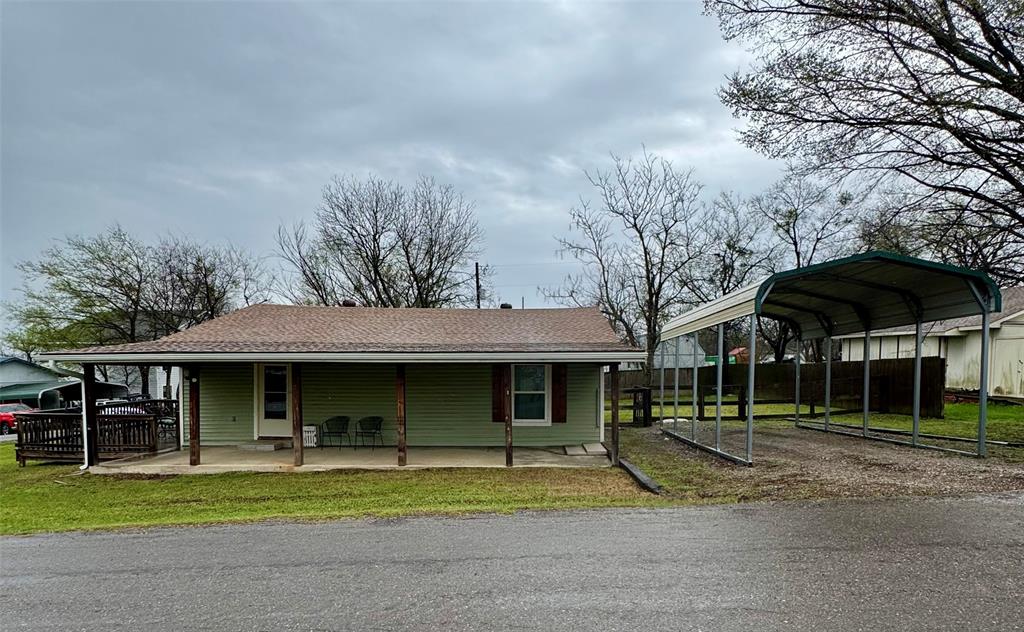 508 Sherry Street Quinlan, TX 75474 - Photo 20 of 20 a view of a house with a yard and large trees