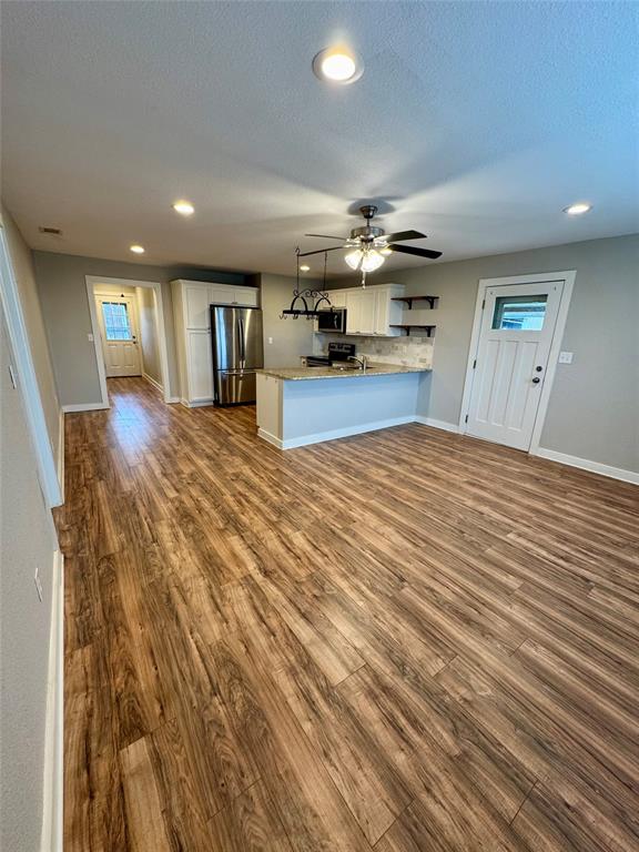 508 Sherry Street Quinlan, TX 75474 - Photo 2 of 20 a view of empty room with kitchen and window