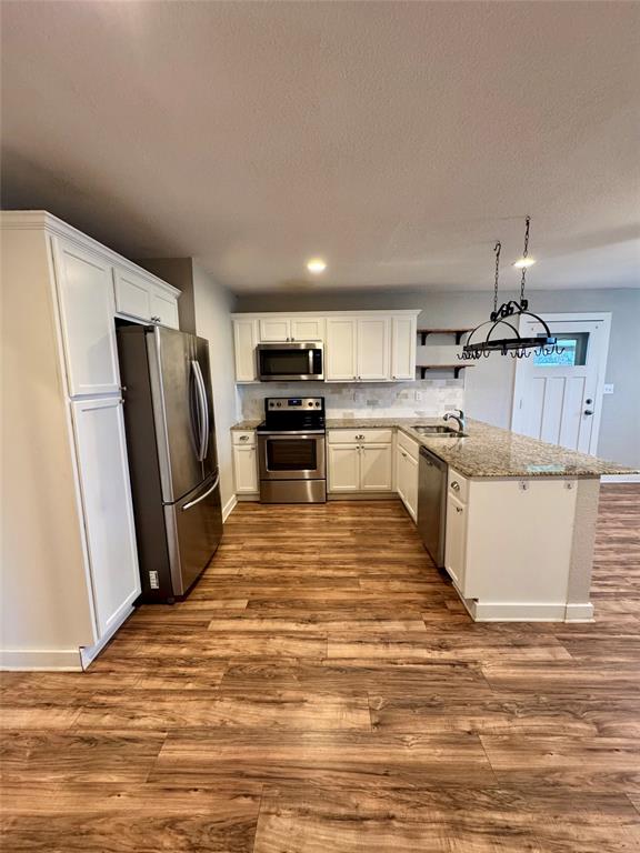 508 Sherry Street Quinlan, TX 75474 - Photo 4 of 20 a kitchen with stainless steel appliances granite countertop a refrigerator sink and stove