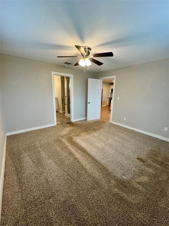 508 Sherry Street Quinlan, TX 75474 - Photo 6 of 20 a view of an empty room with window and a kitchen
