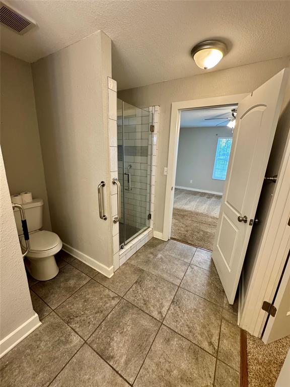 508 Sherry Street Quinlan, TX 75474 - Photo 9 of 20 a bathroom with a toilet and a shower