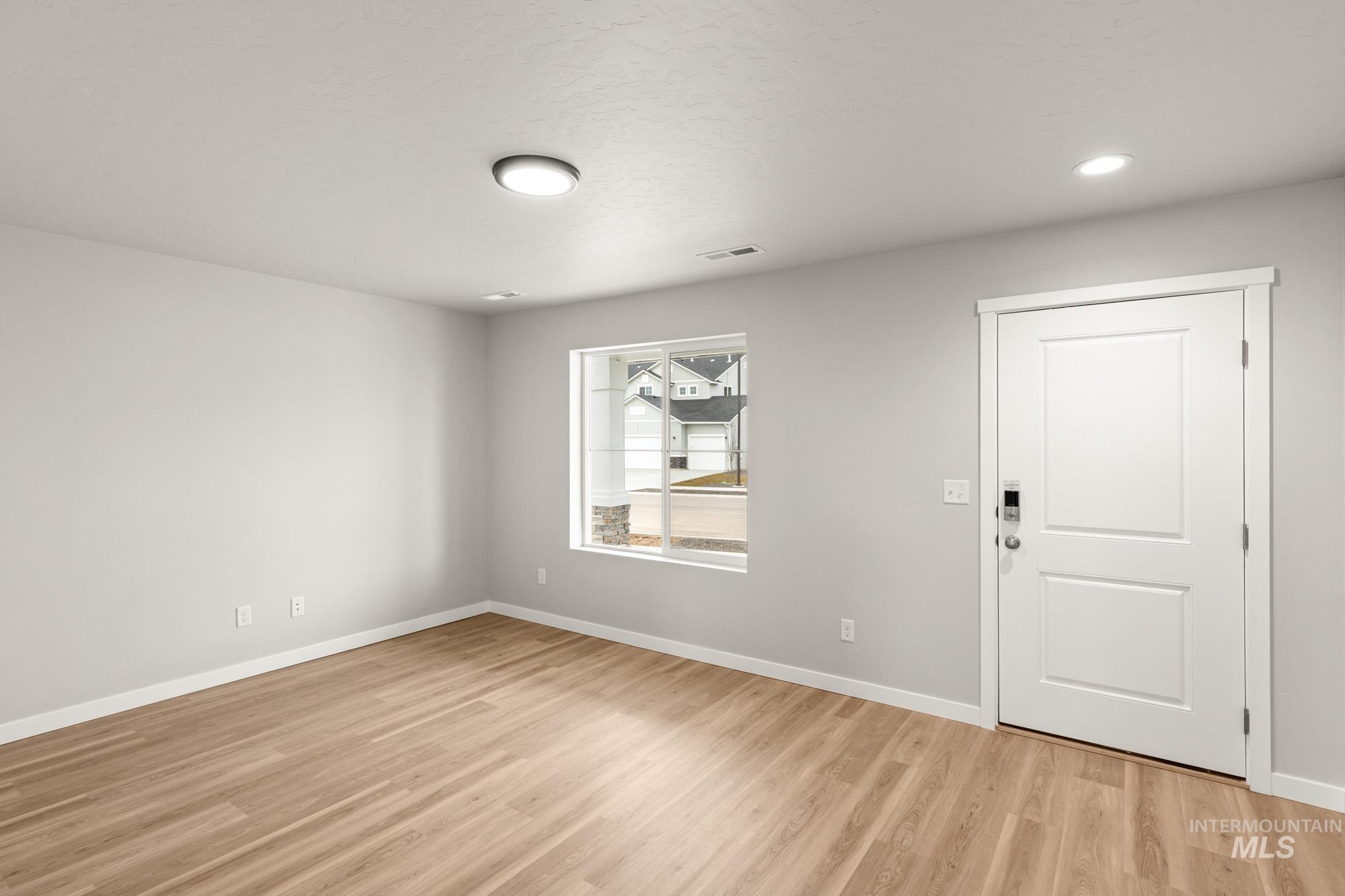 1515 Long Pond Street Middleton, ID 83644 - Photo 10 of 25 Empty room with light wood-style flooring and recessed lighting