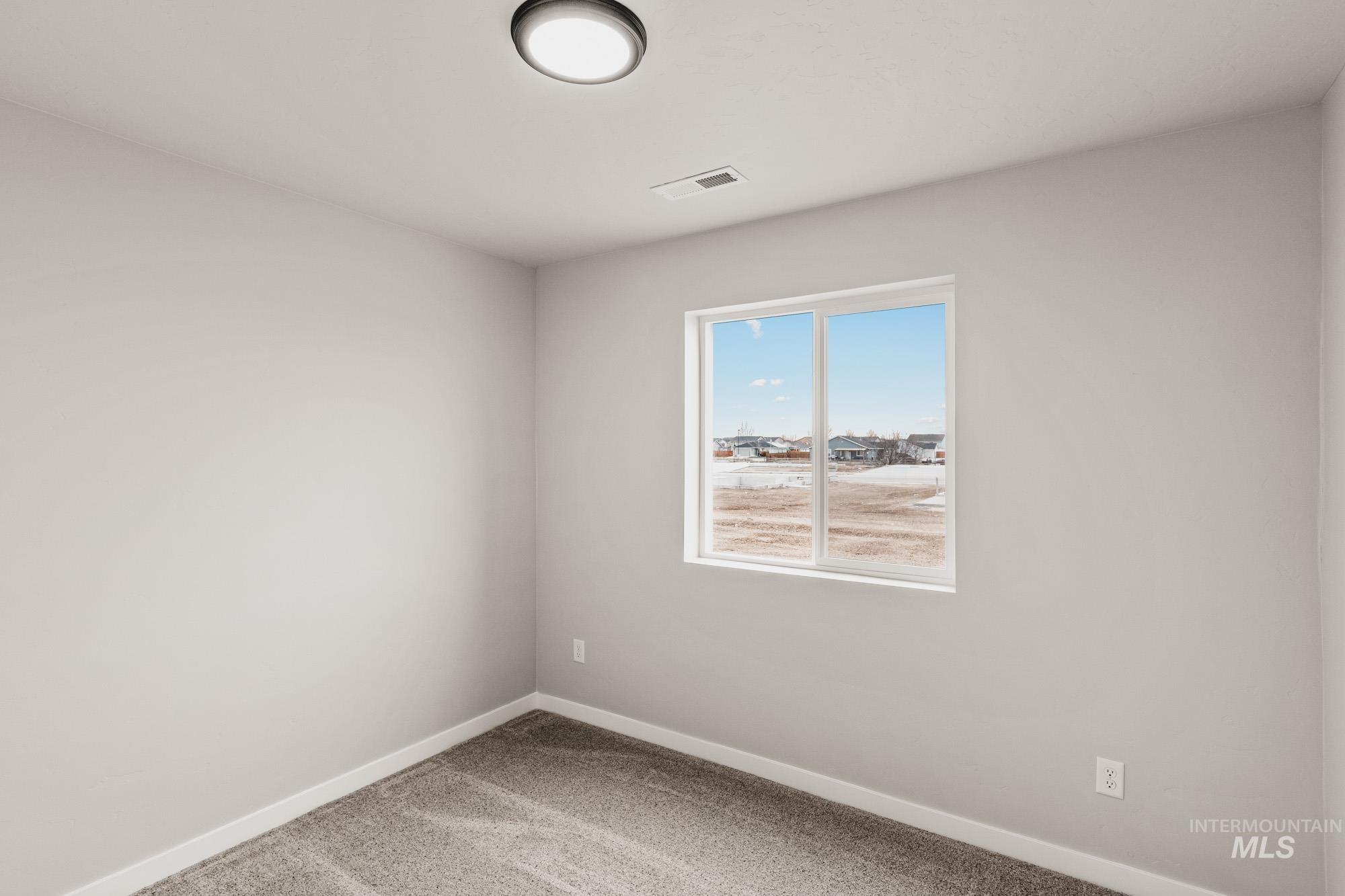 1515 Long Pond Street Middleton, ID 83644 - Photo 12 of 25 Unfurnished room featuring baseboards and light carpet