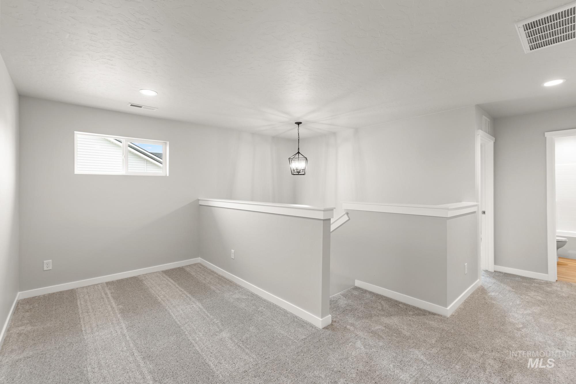 1515 Long Pond Street Middleton, ID 83644 - Photo 14 of 25 Empty room featuring light carpet and recessed lighting