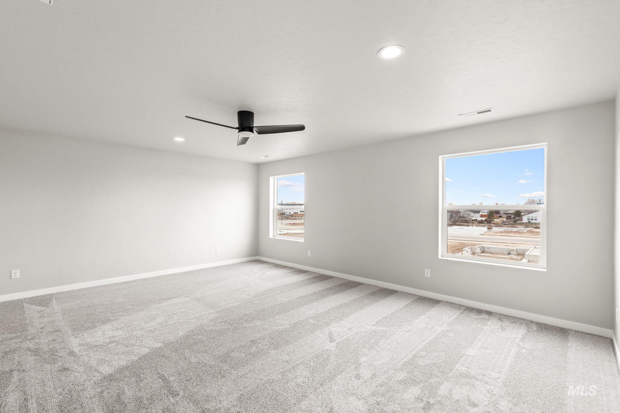 1515 Long Pond Street Middleton, ID 83644 - Photo 15 of 25 Spare room with light colored carpet, ceiling fan, and recessed lighting