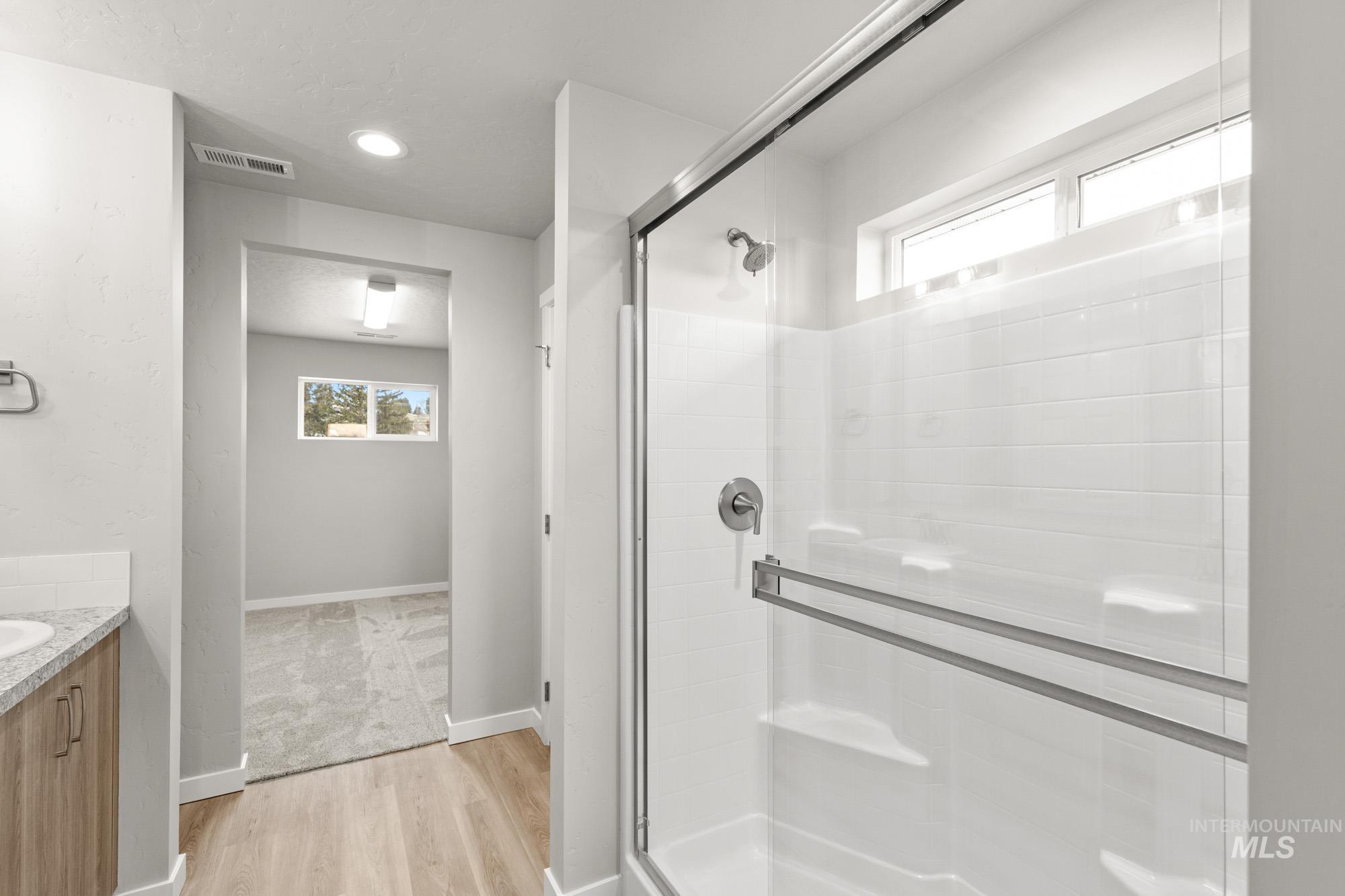 1515 Long Pond Street Middleton, ID 83644 - Photo 16 of 25 Full bath featuring a shower stall, vanity, light wood finished floors, and recessed lighting