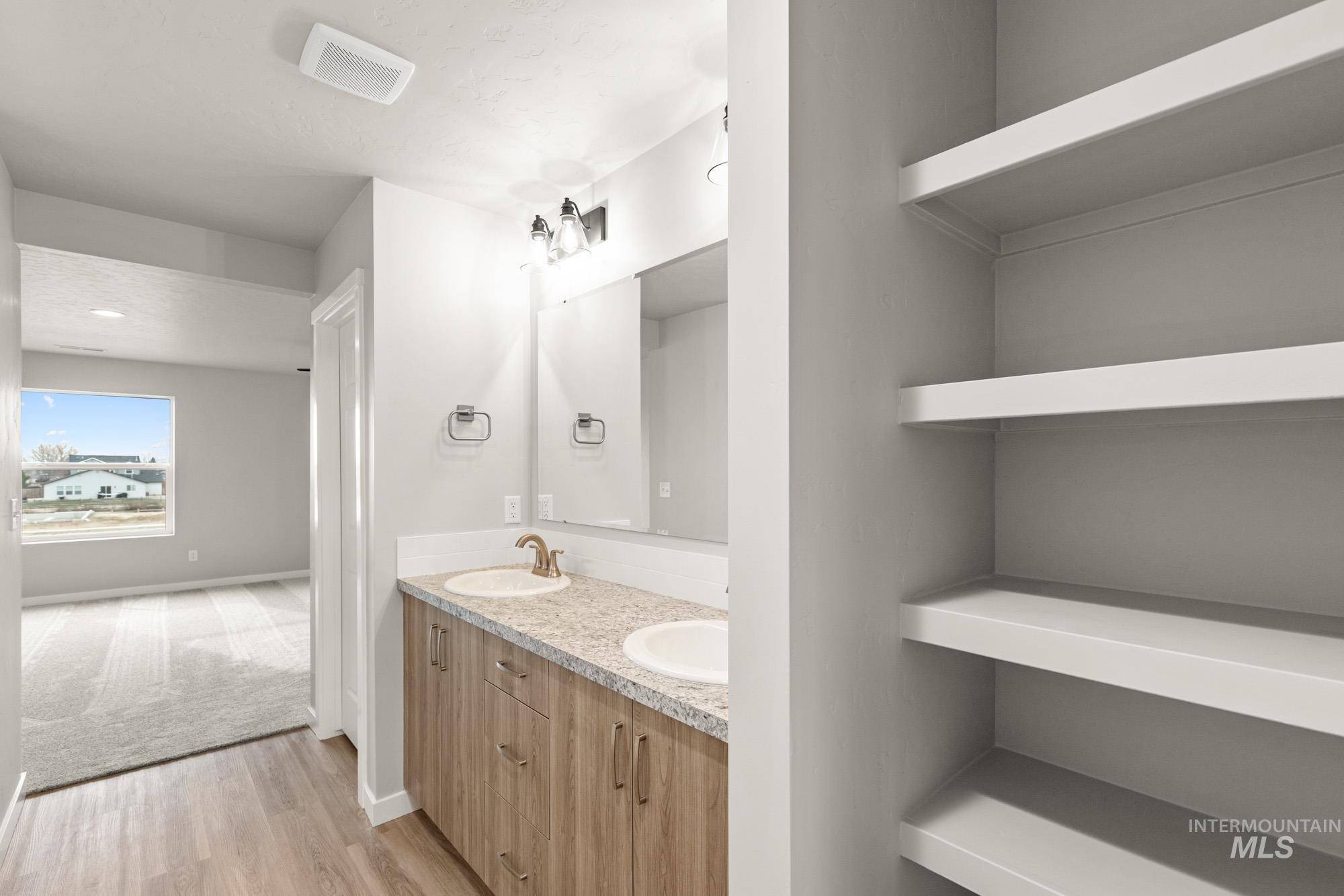 1515 Long Pond Street Middleton, ID 83644 - Photo 18 of 25 Bathroom featuring double vanity and light wood-style flooring