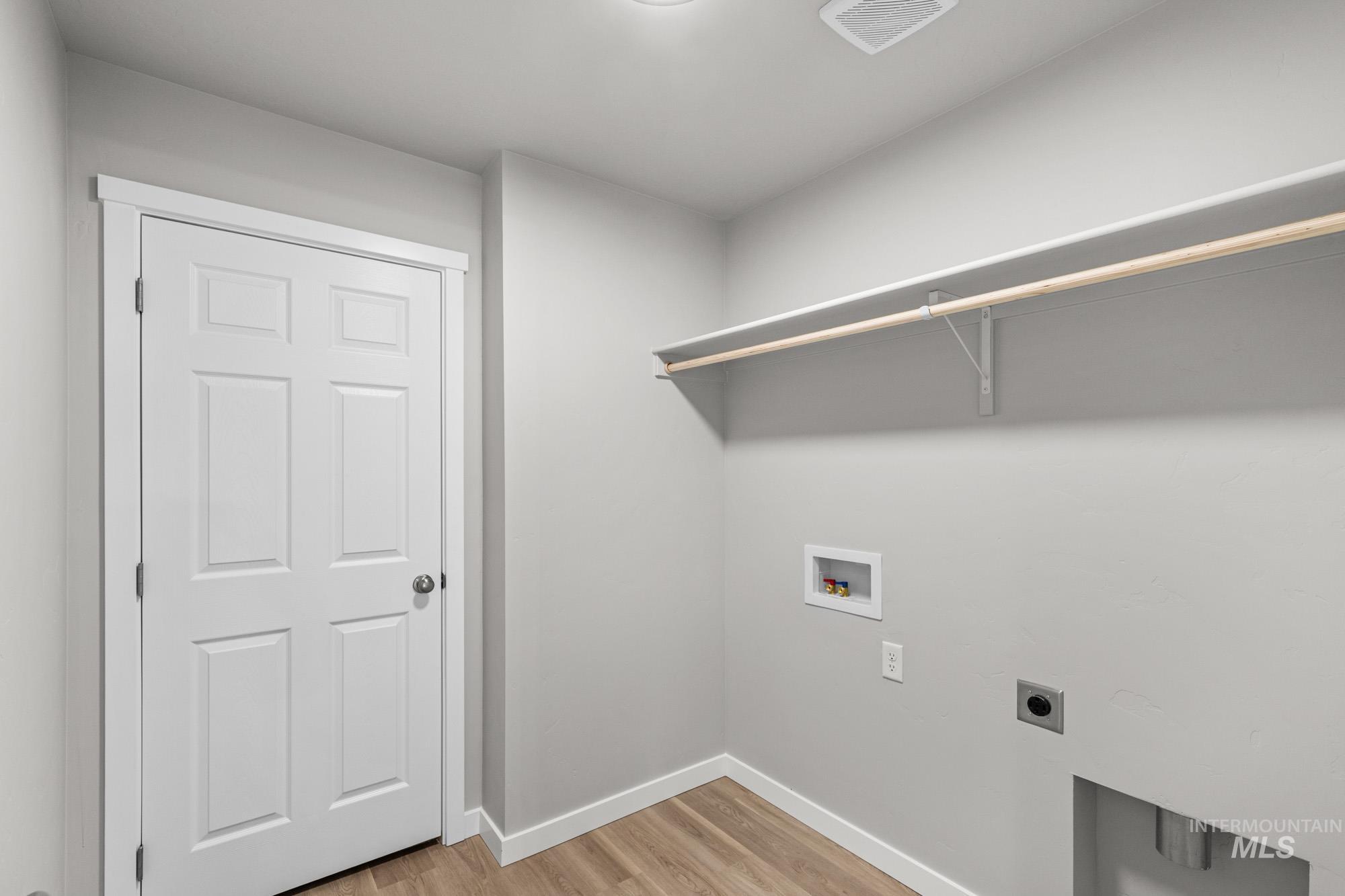 1515 Long Pond Street Middleton, ID 83644 - Photo 19 of 25 Laundry room featuring light wood finished floors, electric dryer hookup, and hookup for a washing machine